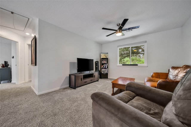 carpeted living room featuring a textured ceiling and ceiling fan