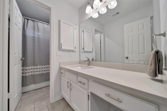 bathroom with tile patterned floors and vanity