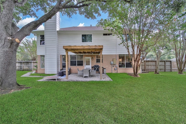 rear view of house with a yard and a patio area