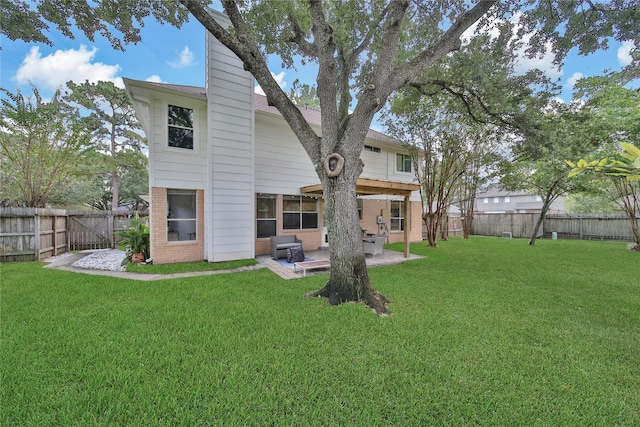 rear view of property with a patio area and a lawn