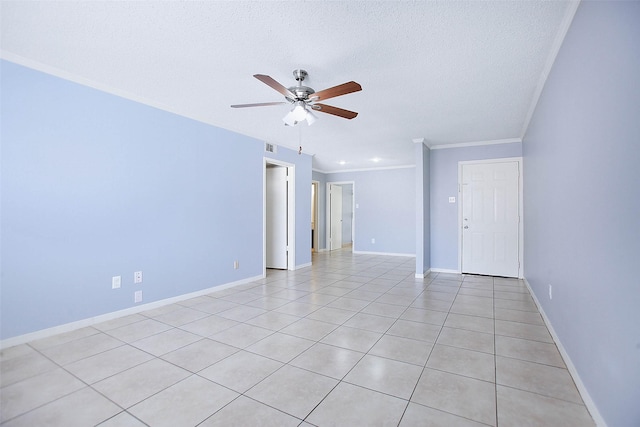 empty room featuring ceiling fan, ornamental molding, a textured ceiling, and light tile patterned floors