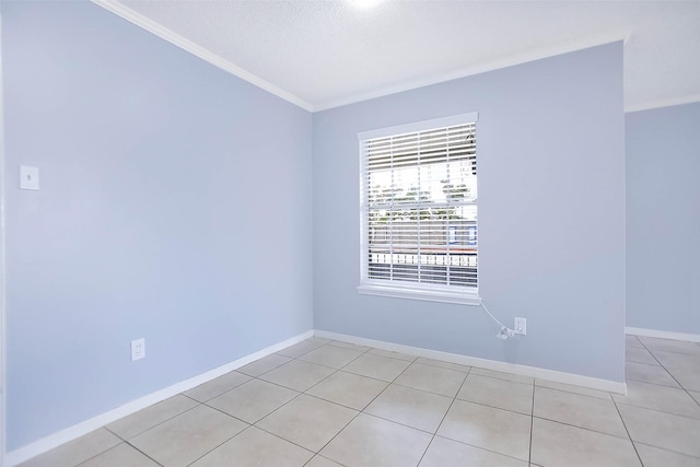 unfurnished room with light tile patterned floors and crown molding