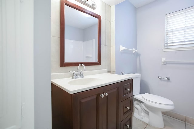 bathroom featuring vanity, tile patterned flooring, and toilet