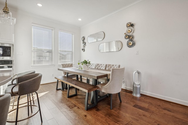 dining space featuring ornamental molding and wood-type flooring