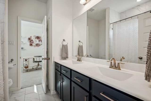 bathroom featuring vanity and toilet