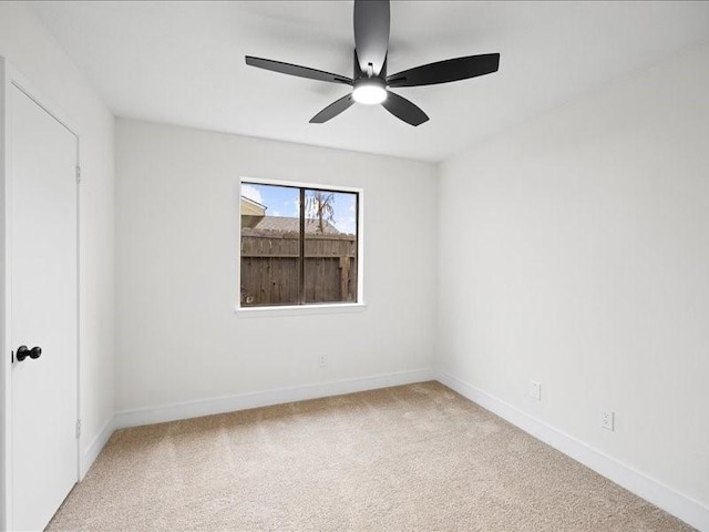 carpeted empty room featuring ceiling fan