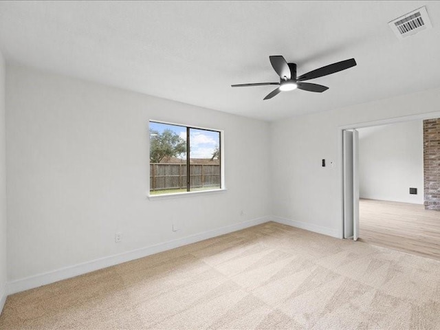 empty room featuring light carpet and ceiling fan