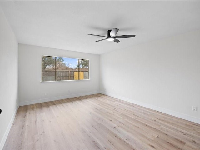 empty room with ceiling fan and light hardwood / wood-style flooring