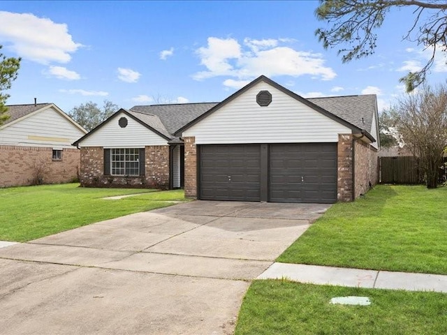 single story home featuring a garage and a front lawn