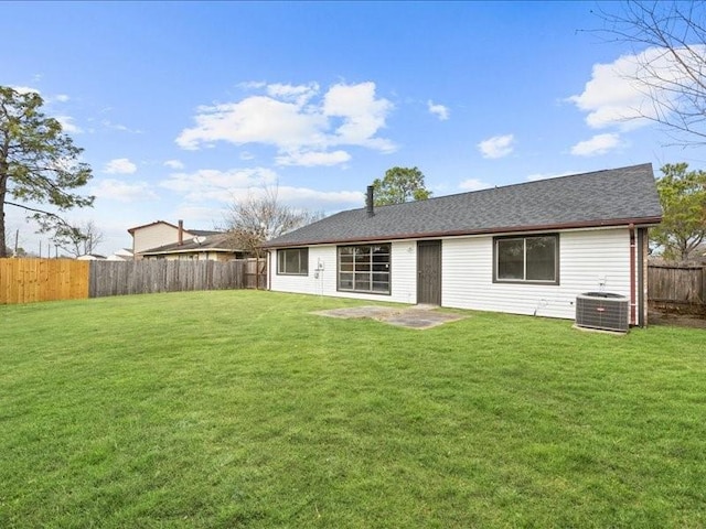 back of house with cooling unit, a lawn, and a patio