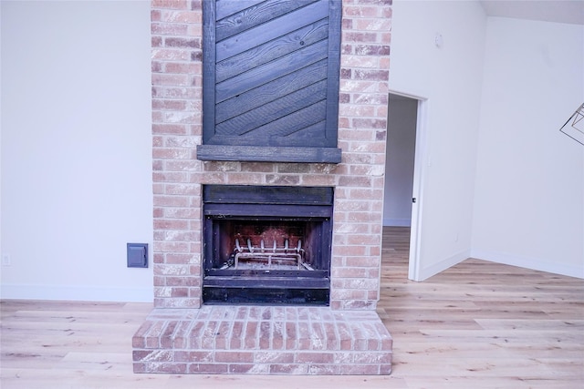 details featuring hardwood / wood-style floors and a fireplace