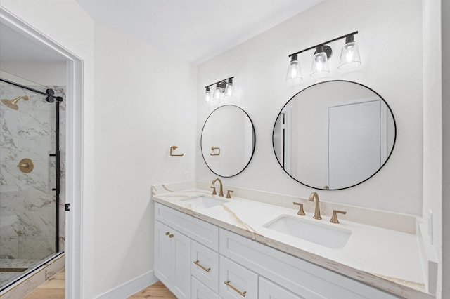 bathroom featuring vanity and an enclosed shower