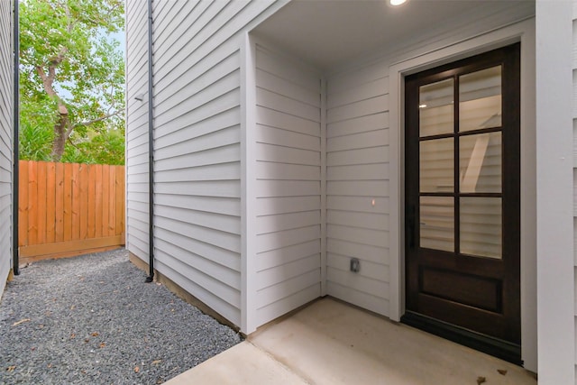 view of exterior entry featuring a patio area