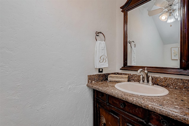 bathroom featuring vanity, lofted ceiling, and ceiling fan