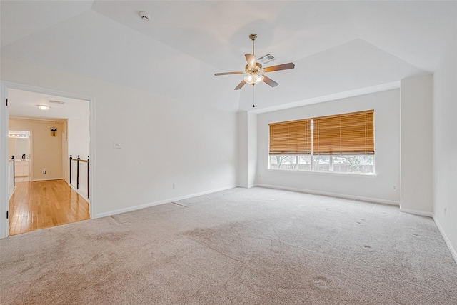 empty room featuring ceiling fan and light colored carpet