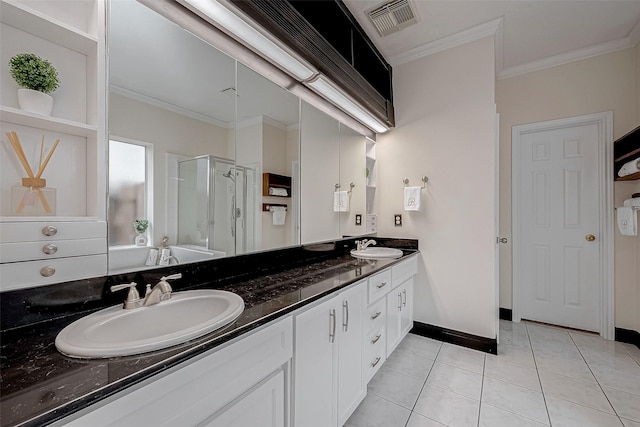 bathroom with tile patterned floors, ornamental molding, a shower with door, and vanity