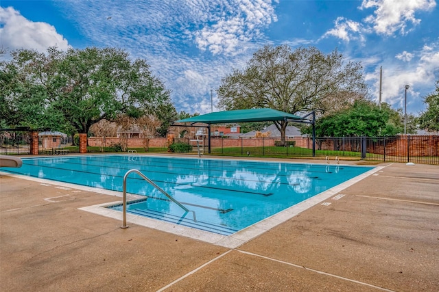 view of pool with a water slide and a patio