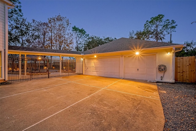 view of garage at dusk