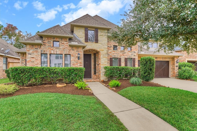 view of front of property featuring a garage and a front yard