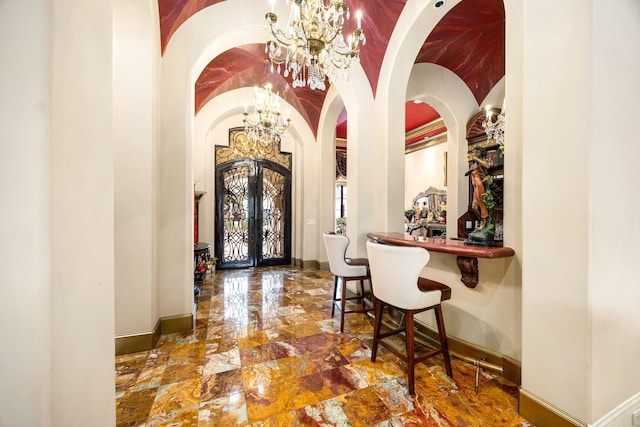 interior space with a notable chandelier and french doors