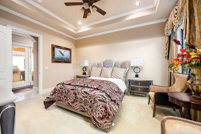 carpeted bedroom featuring a raised ceiling, crown molding, and ceiling fan