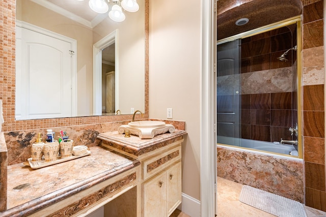 bathroom with vanity, bath / shower combo with glass door, and ornamental molding