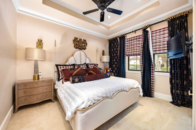 bedroom with light carpet, ornamental molding, a raised ceiling, and ceiling fan