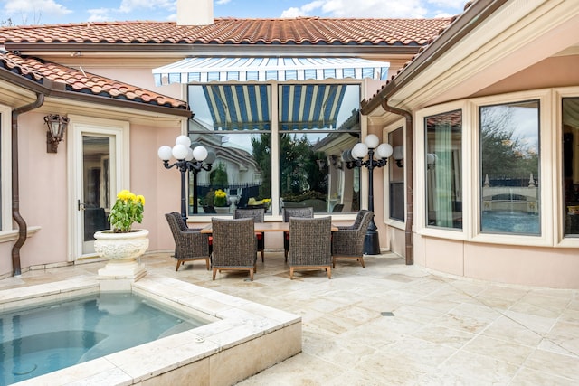 view of patio / terrace featuring an in ground hot tub