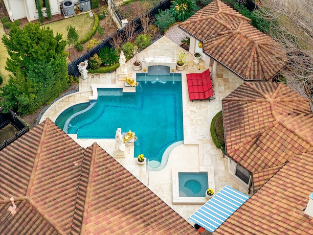 view of pool featuring an in ground hot tub and central AC unit