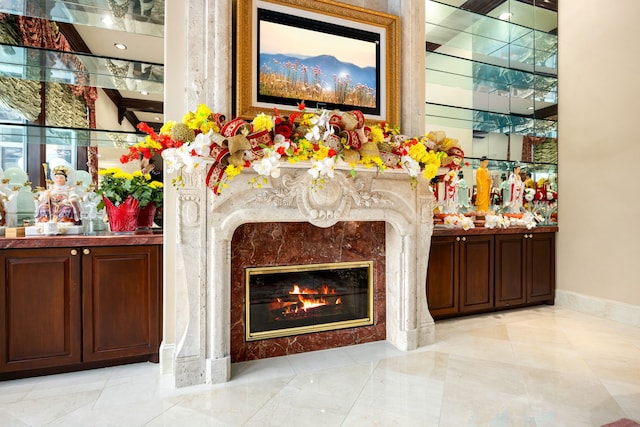 interior space with dark brown cabinets and a high end fireplace