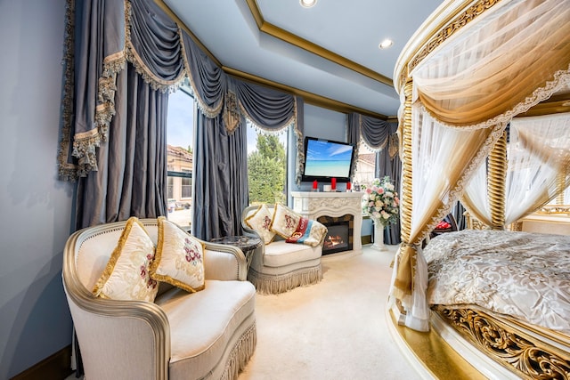 carpeted bedroom featuring crown molding, a tray ceiling, and access to outside