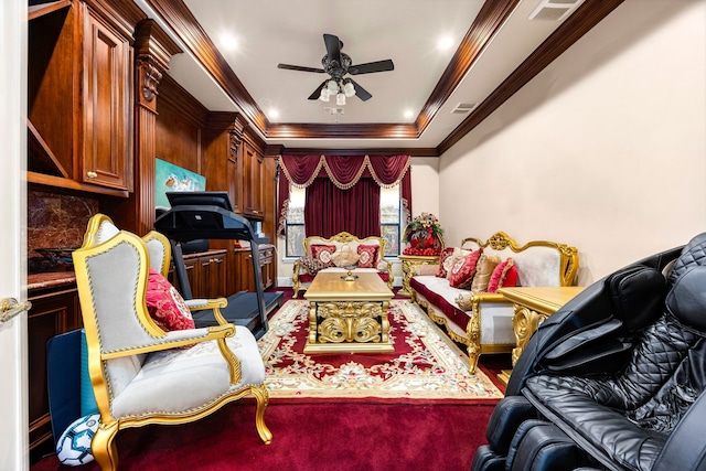 interior space with crown molding, ceiling fan, and a tray ceiling