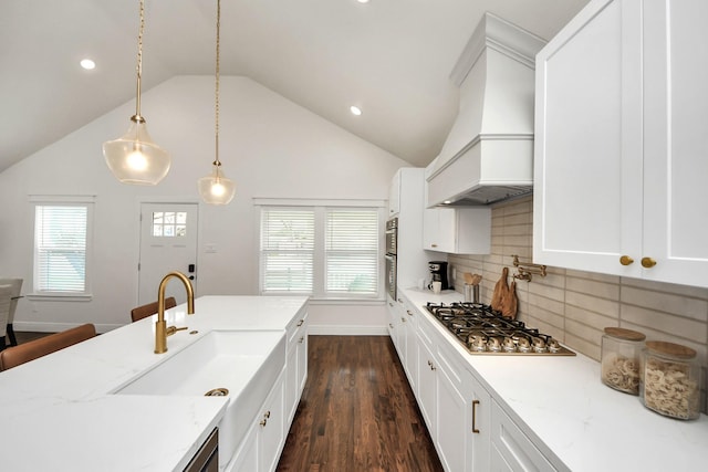 1819 Studewood St, Houston, TX 77008 - kitchen featuring stainless steel gas cooktop, premium range hood, dark wood-style flooring, recessed lighting, and a sink