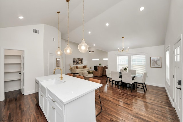 1819 Studewood St, Houston, TX 77008 - kitchen with a chandelier, an island with sink, stainless steel dishwasher, a sink, and light countertops
