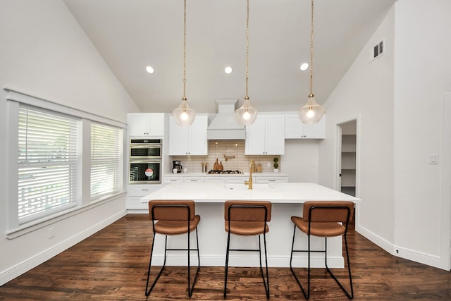 1819 Studewood St, Houston, TX 77008 - kitchen featuring premium range hood, stainless steel double oven, high vaulted ceiling, a kitchen bar, and tasteful backsplash