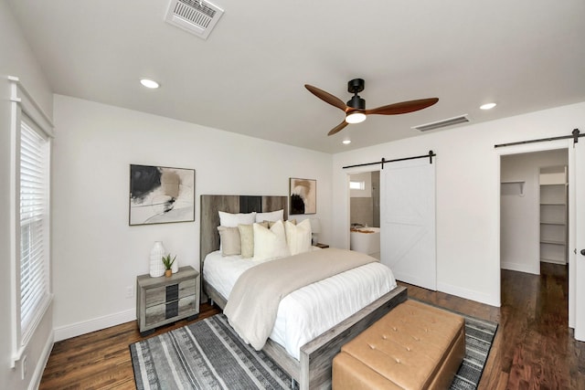 1819 Studewood St, Houston, TX 77008 - bedroom with a barn door, wood finished floors, baseboards, ceiling fan, and recessed lighting