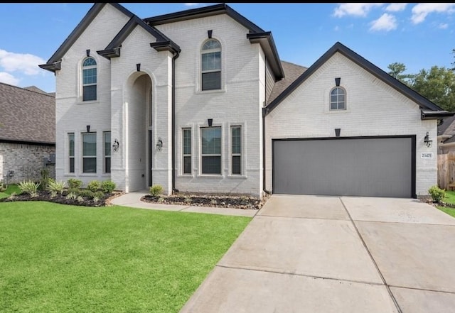 french provincial home featuring a garage and a front yard