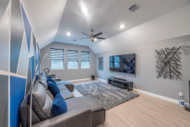 living room featuring lofted ceiling, hardwood / wood-style floors, and ceiling fan