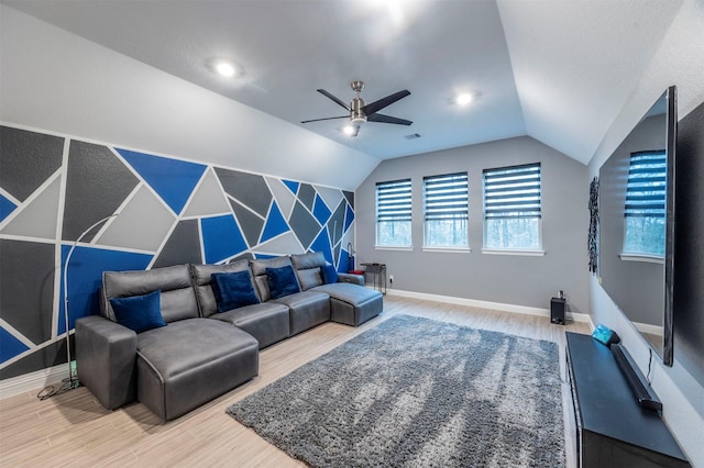 living room featuring lofted ceiling, hardwood / wood-style flooring, and ceiling fan