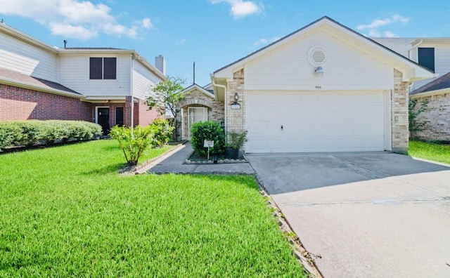 view of front of house with a garage and a front yard