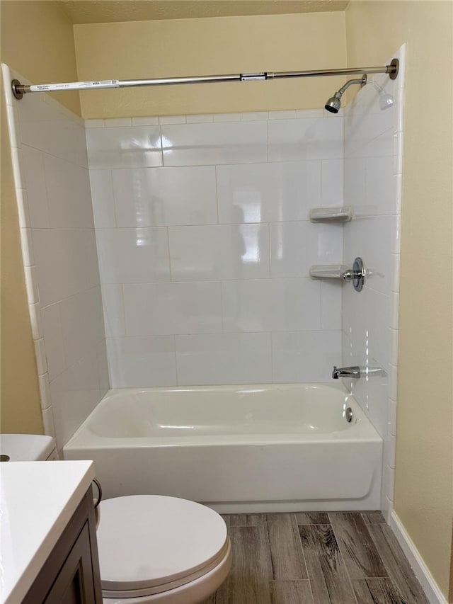 full bathroom with vanity, tiled shower / bath, and toilet