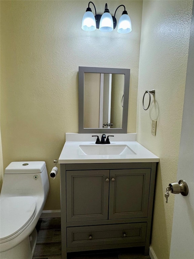 bathroom featuring vanity and toilet