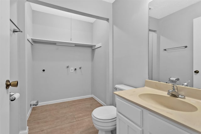 bathroom with wood-type flooring, vanity, and toilet