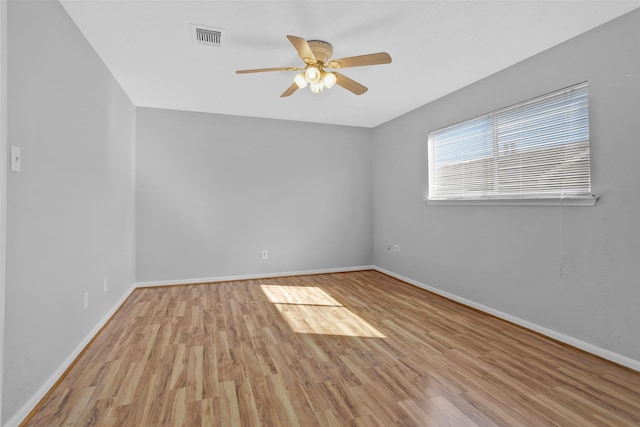 spare room with ceiling fan and light wood-type flooring