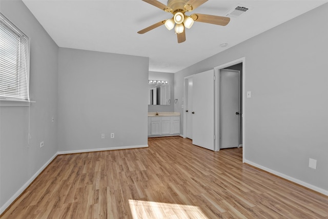 interior space featuring sink, light hardwood / wood-style floors, and ceiling fan