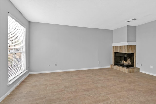 unfurnished living room with a tile fireplace