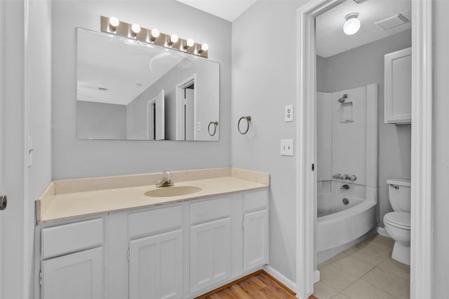 full bathroom with tile patterned floors, vanity, toilet, and tub / shower combination