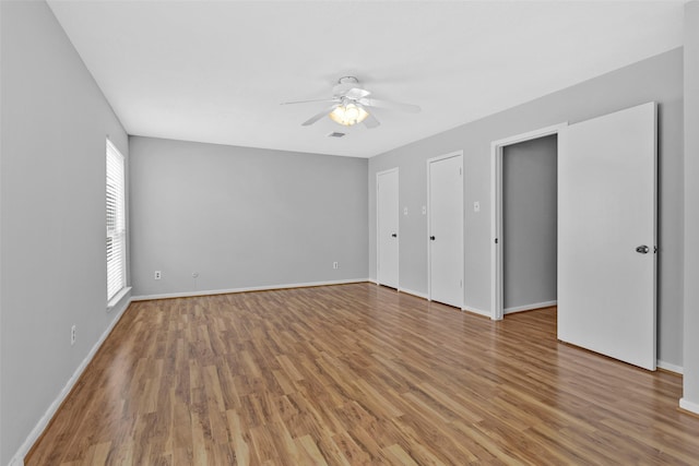 empty room with hardwood / wood-style flooring and ceiling fan