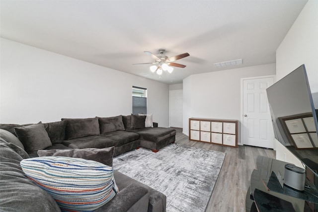 living room featuring hardwood / wood-style flooring and ceiling fan