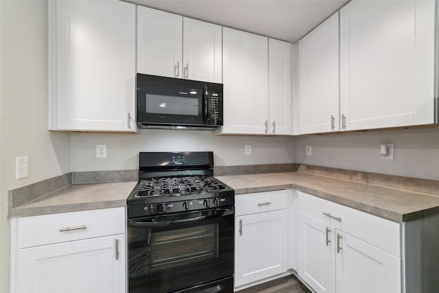 kitchen with white cabinetry and black appliances